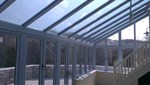 Duck egg blue conservatory with Residence 9 windows and aluminium bifolding doors