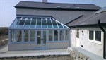 Duck egg blue conservatory with Residence 9 windows and aluminium bifolding doors