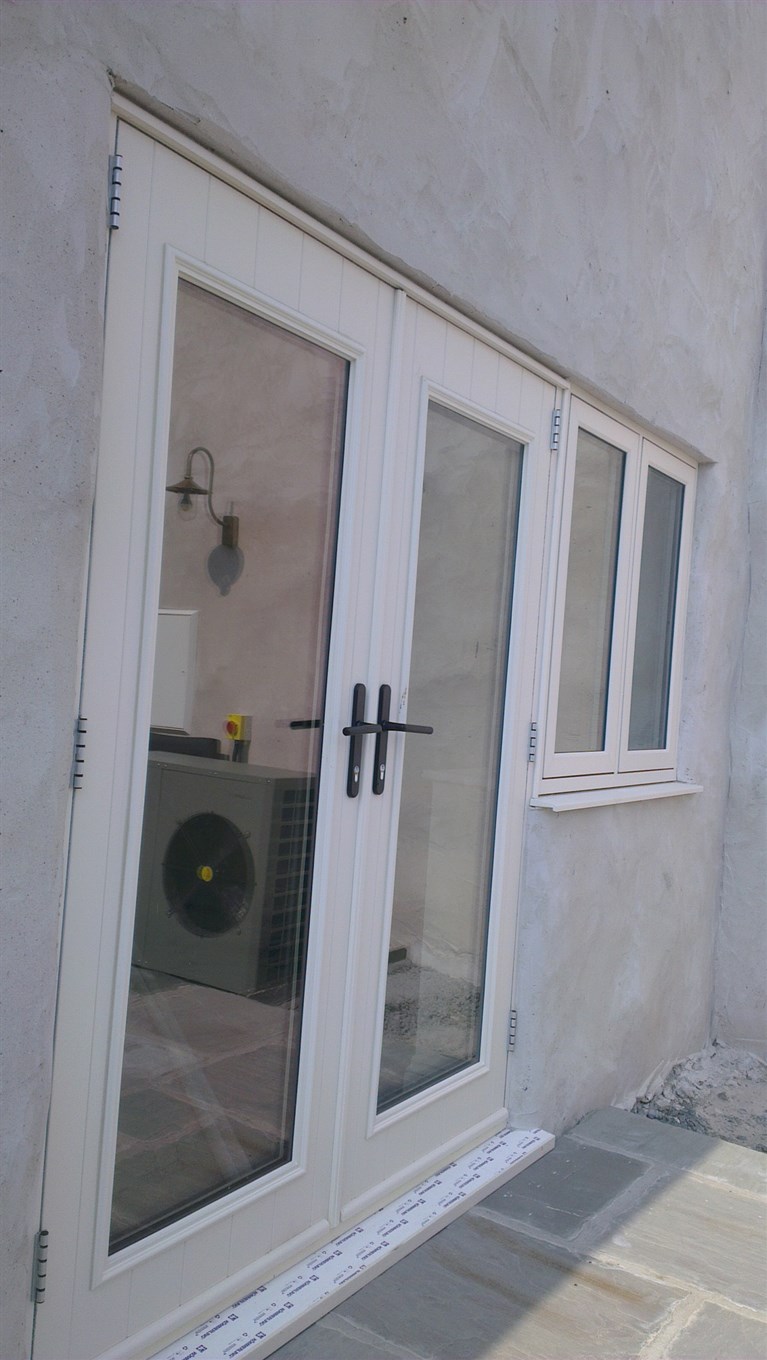 Duck egg blue conservatory with Residence 9 windows and aluminium bifolding doors